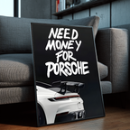 Need Money for Porsche framed poster leaning against a gray sofa in a modern interior with wood floors, bookshelves, and contemporary decor.